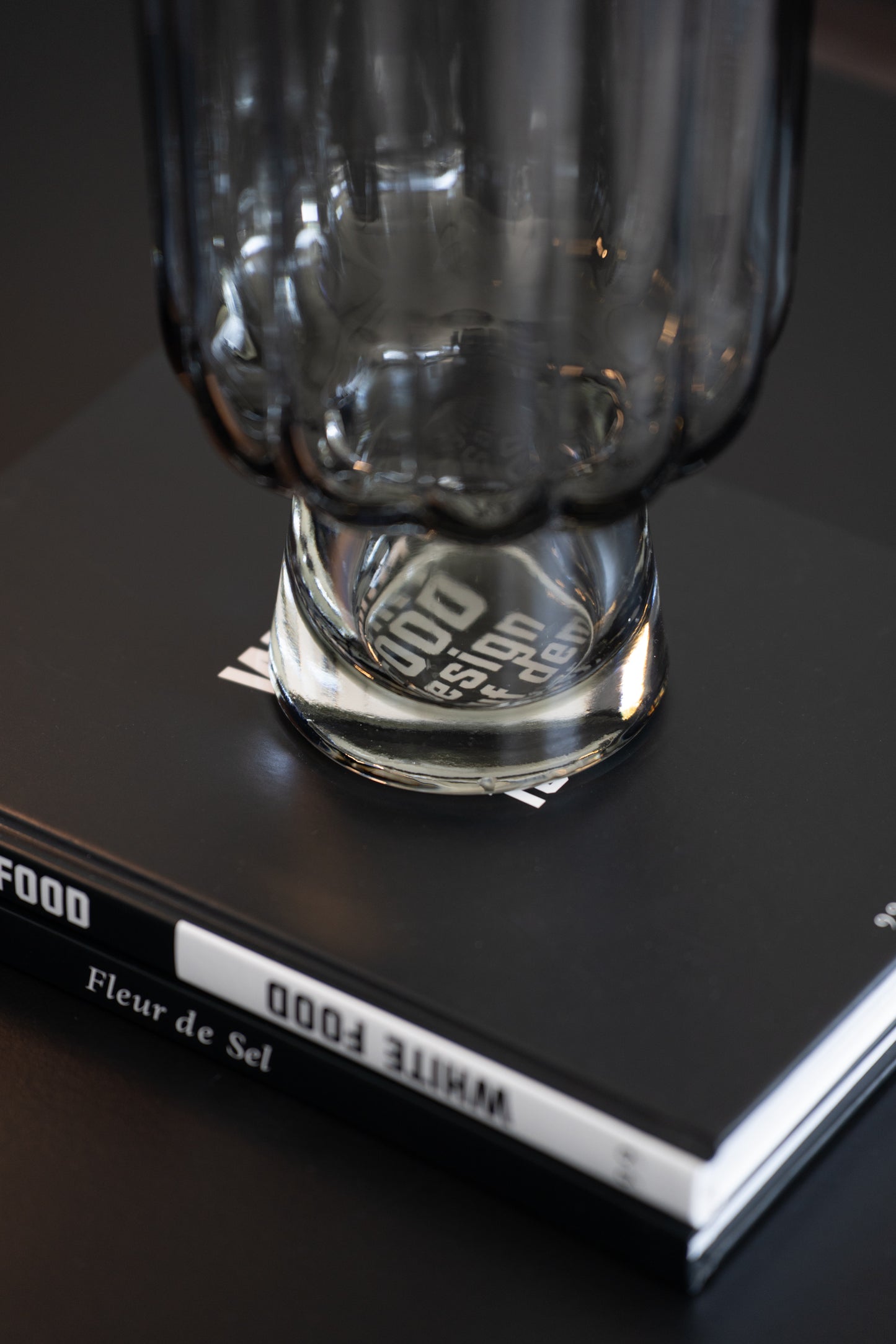 Geriffelte graue Glasvase auf Buch als elegante moderne Tischdekoration