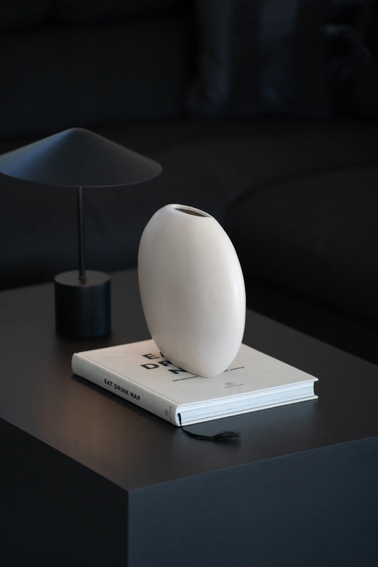 Weiße minimalistische Steingutvase als moderne Wohnzimmerdekoration